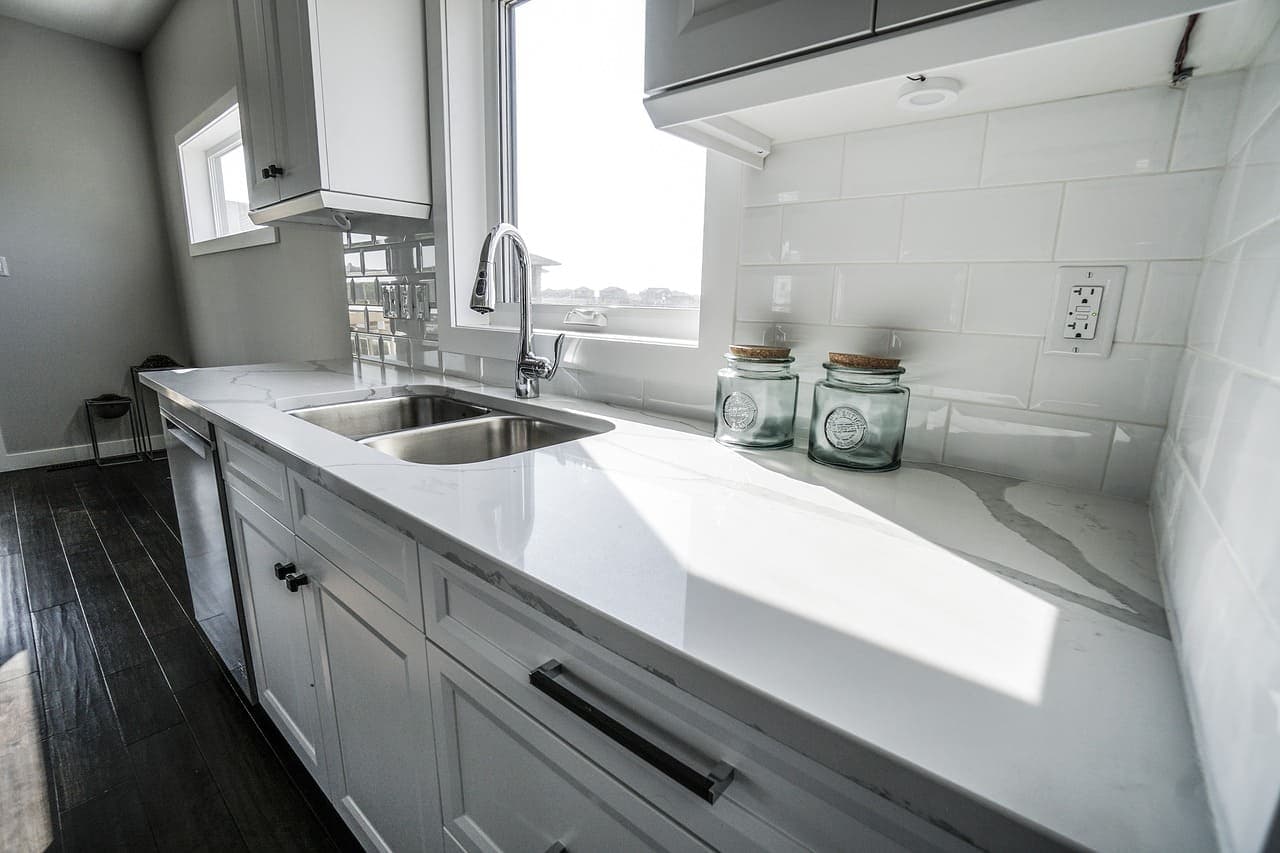 Crisp cabinetry, light quartz surfaces, and an open layout built for everyday cooking.